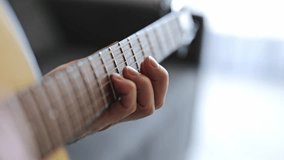 Talented musician plays acoustic guitar at home. Professional freelancer enjoys music. Creative artist composes song indoors. - Powered by Shutterstock - Get 15% off with code: PIKWIZARD15