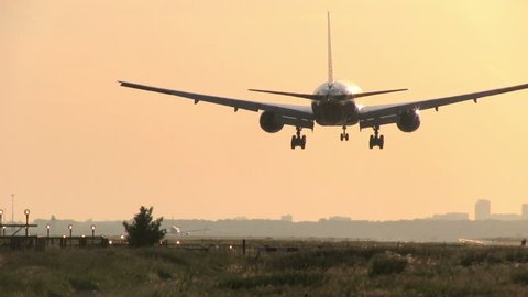 Huge plane landing at dusk