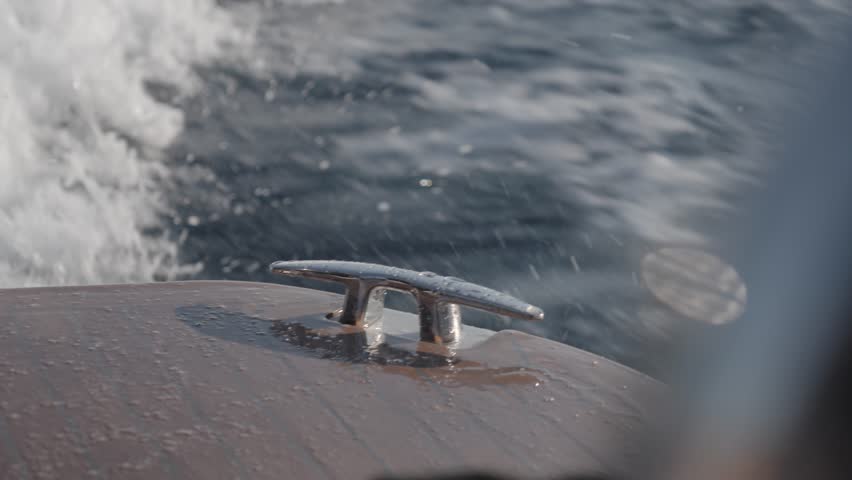 Stainless steel mooring cleat on a boat, splashed with water while sailing