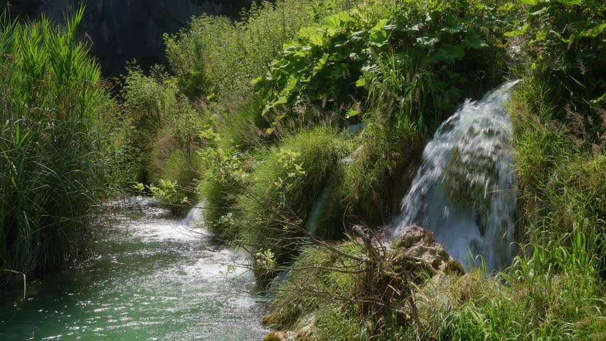 A waterfall with clear water in the famous Croatian Plitvice Lakes National Park, listed as a UNESCO World Heritage site. A popular natural tourist attraction in Croatia.