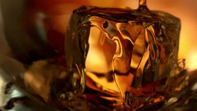 Super Slow Motion Detail Shot of Pouring Whiskey on Ice Cube in Glass at 1000fps. - Powered by Shutterstock - Get 15% off with code: PIKWIZARD15