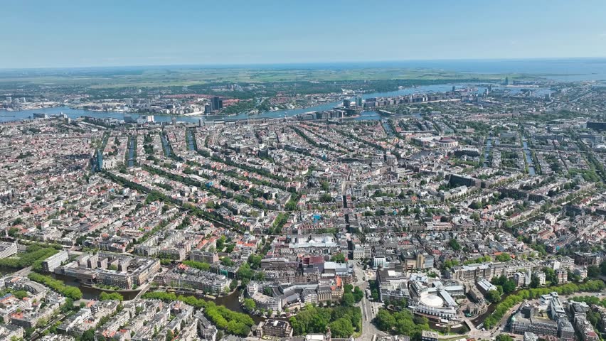 Aerial Inner city of Amsterdam, the Netherlands, with the Rijksmuseum, its canal belt and old mansions and the Dam. The river 