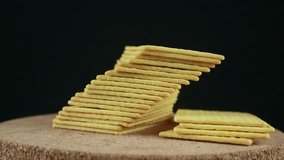 Stack of crispy salted crackers on black background. Rotating display - Powered by Shutterstock - Get 15% off with code: PIKWIZARD15