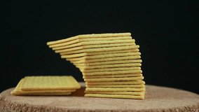 Stack of crispy salted crackers on black background. Rotating display - Powered by Shutterstock - Get 15% off with code: PIKWIZARD15