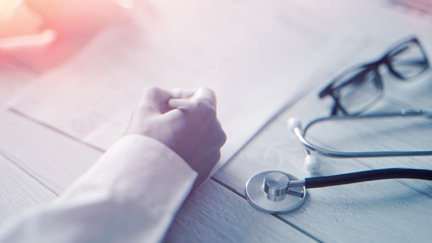 A doctor is writing notes on medical examination or prescribing treatment in health clinic. Physician is filling in patient record. Concept of healthcare or hospital and medicine. Close up - Powered by Shutterstock - Get 15% off with code: PIKWIZARD15