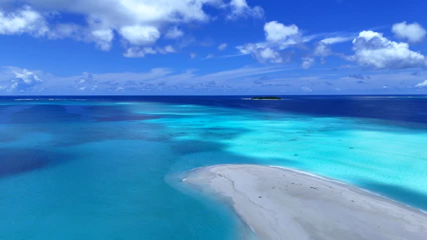 Clouds pass over an island with crystal water. Maldives