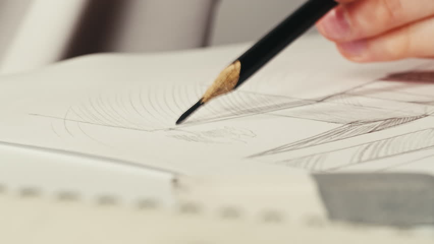Close-up of drawing buildings by pencil on white paper. The architect making sketches for the projection of the building macro. Drawing and sketching lessons