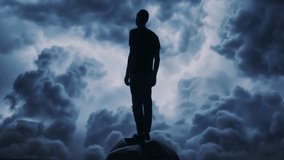Silhouetted Figure Standing On Mountain Peak Against Dramatic Storm Clouds Contemplation Solitude Journey - Powered by Shutterstock - Get 15% off with code: PIKWIZARD15