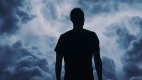 Silhouette Man Looking At Stormy Sky Dark Clouds Dramatic Weather Moody Atmosphere - Powered by Shutterstock - Get 15% off with code: PIKWIZARD15