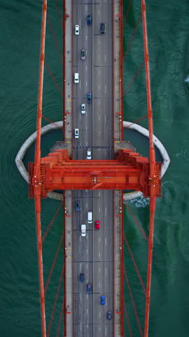 Over head aerial view of the Golden Gate Bridge. Full of traffic. San Francisco, California. United Sates. US route 101 and SR 1 full of cars. Shot i 
 8K.