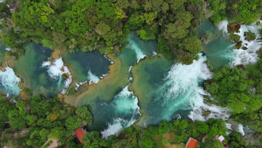 Aerial top view of beautiful Krka Waterfalls in Krka National Park, green foliage and turquoise water, Croatia, 4k
