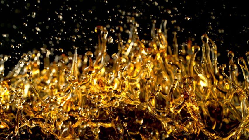 Super Slow Motion Shot of Splashing Golden Liquid Isolated on Black Background at 1000fps.