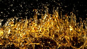Super Slow Motion Shot of Splashing Golden Liquid Isolated on Black Background at 1000fps. - Powered by Shutterstock - Get 15% off with code: PIKWIZARD15