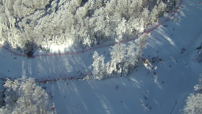 Aerial helicopter shot of ski track with people skiing, Medvednica, peak Sljeme