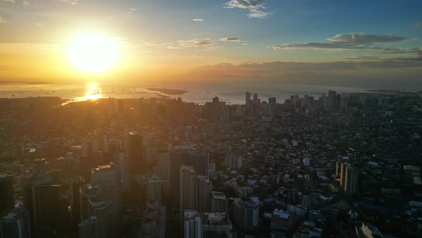 Aerial view of skyscrapers buildings in Makati business district and Manila city at sunset, capital of Philippines, panorama 4k