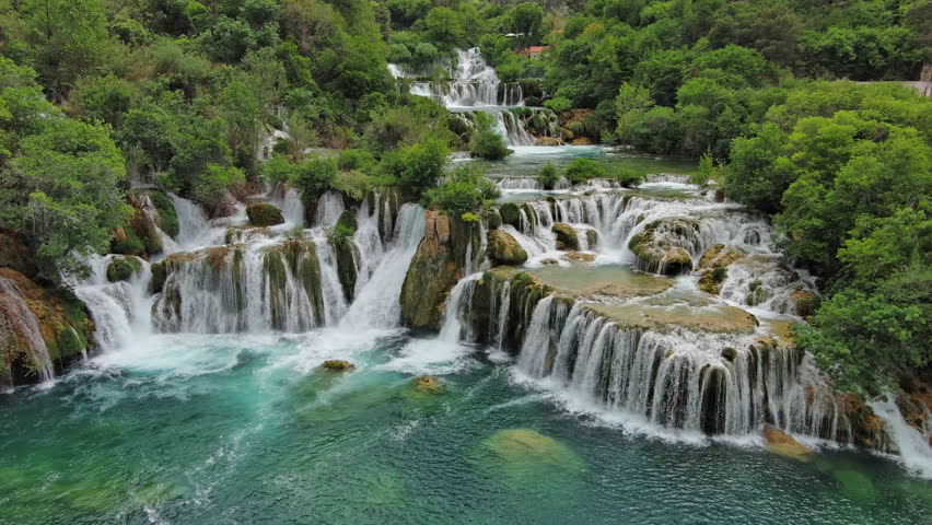 Aerial view of beautiful Krka Waterfalls in Krka National Park, green foliage and turquoise water, Croatia, 4k