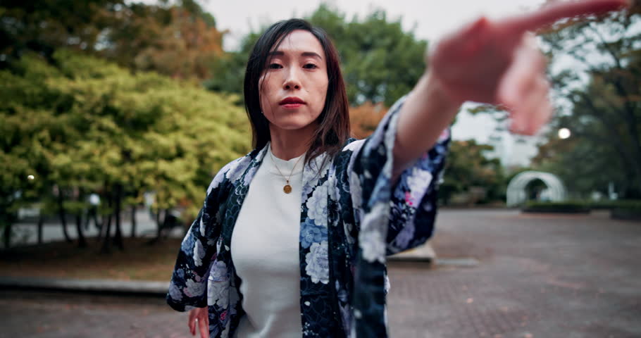 Dancer, performance and face of Asian woman in park with movement, contemporary art and style. Creative dancing, fashion and portrait of Japanese person in town for practice, culture and choreography