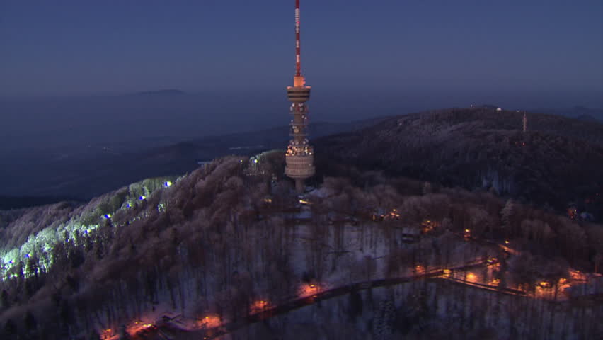 Radio and TV tower on the top of the peak Sljeme at sunset. Aerial helicopter