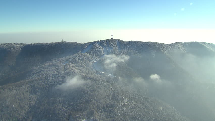 Radio and TV tower on the top of the peak Sljeme, winter landscape. Aerial
