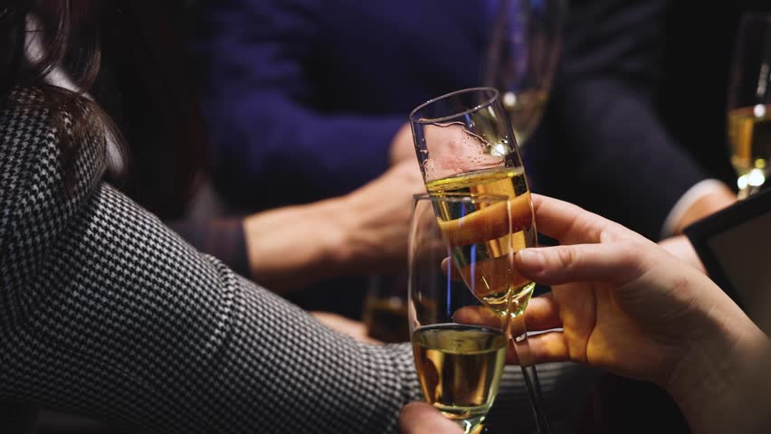 Group of businessmen celebrate, closing successful concluded deal, guests clinking raise glasses with alcohol, sparkling wine, toasting and cheering, colleagues team in office on corporate party event
