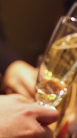 Group of businessmen celebrate, closing successful concluded deal, guests clinking raise glasses with alcohol, sparkling wine, toasting and cheering, colleagues team in office on corporate party event