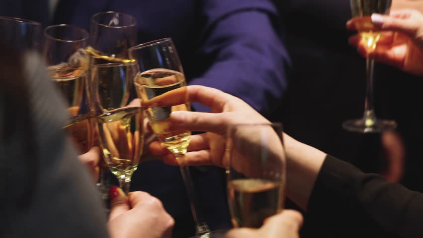 Group of businessmen celebrate, closing successful concluded deal, guests clinking raise glasses with alcohol, sparkling wine, toasting and cheering, colleagues team in office on corporate party event