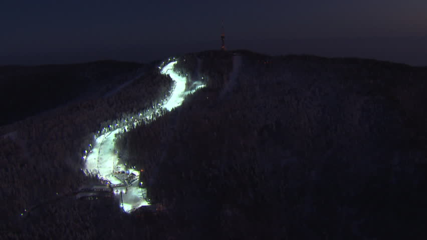 A ski track and TV tower on the top of the peak Sljeme at night. Aerial