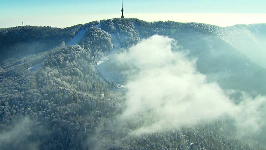 A ski track and TV tower on the top of the peak Sljeme, winter landscape. Aerial