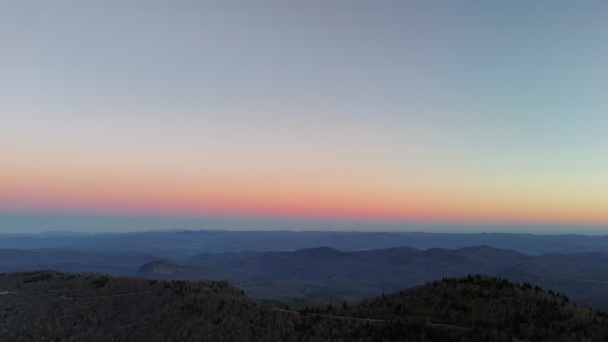 Experience breathtaking mountain beauty at sunset in this aerial view