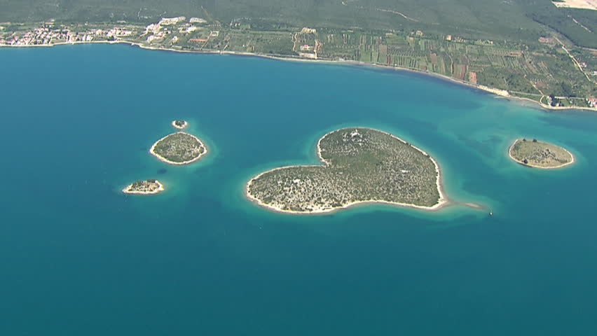 Aerial helicopter shot of a beautiful and unique heart-shaped island of