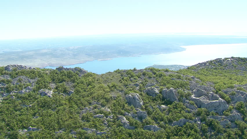 Aerial shot of rocky mountain ridges and view spreading over the Adriatic sea