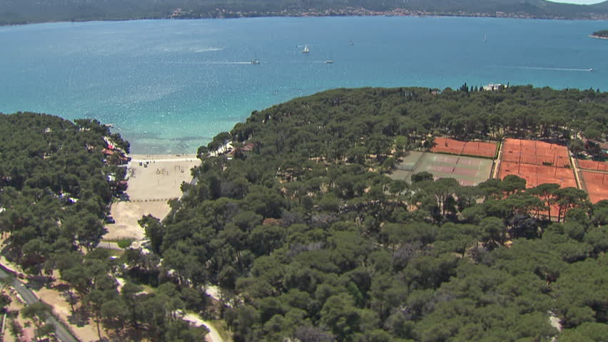 Aerial shot of tennis courts surrounded by mediterranean vegetation, Adriatic
