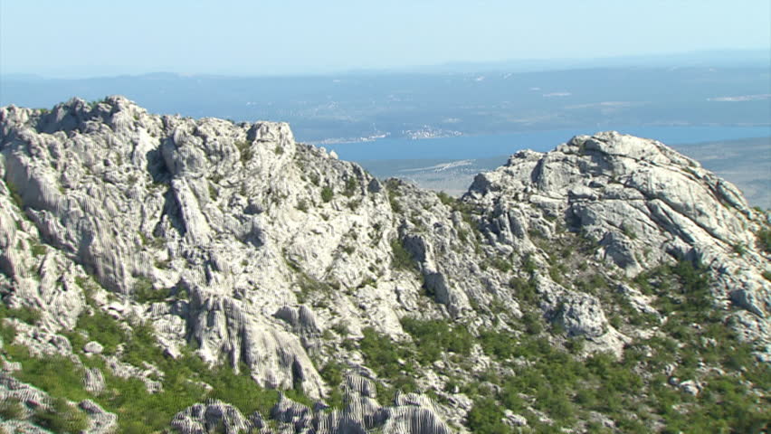 Aerial shot of rocky mountain ridges and view spreading over the Adriatic sea