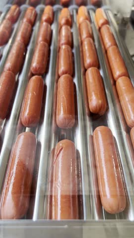 Automatic electric grill with sausages. For cooking. Can be used show how delicious appetizers are prepared and hot dogs. Close-up.