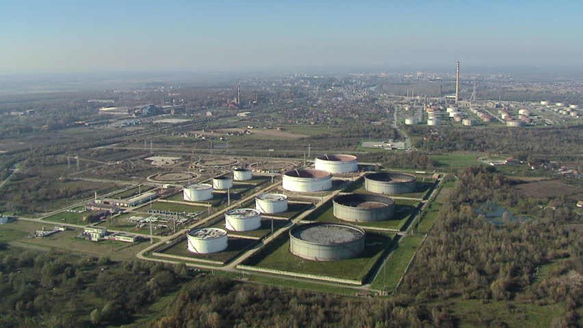 Aerial helicopter shot of refinery oil storage tanks