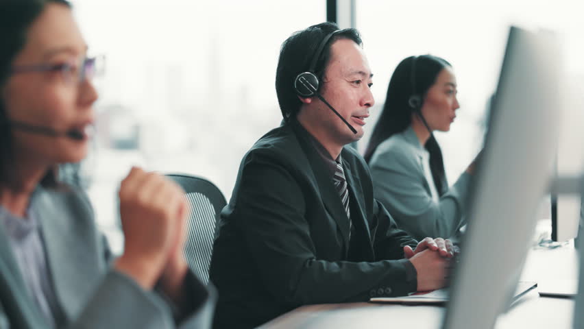 Businessman, consultant and call center with headphones at agency for customer service or telemarketing at office. Japanese, man or agent consulting with headset for online advice, help or assistance - Powered by Shutterstock - Get 15% off with code: PIKWIZARD15