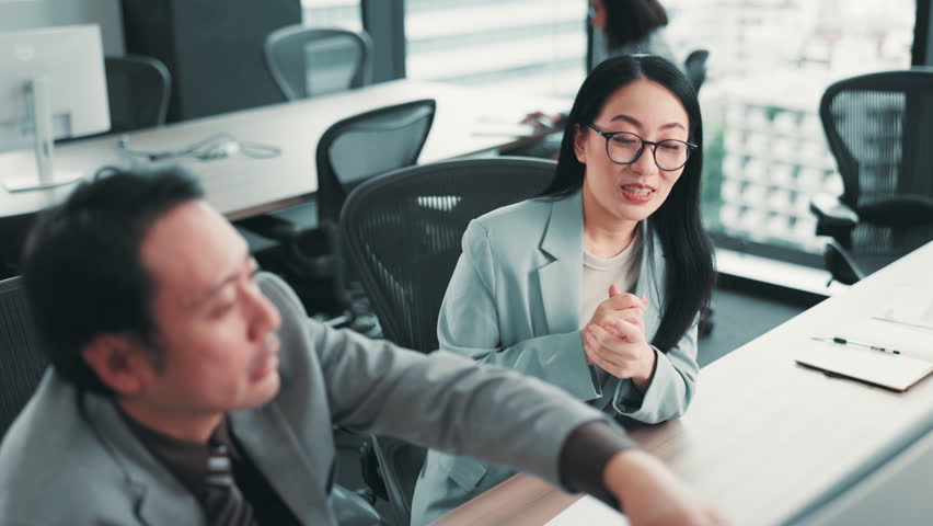 Japanese, business and people with mentor in office for training support, discussion and help of finance report. Staff, explain and computer with coaching, kpi feedback and investment advice in Japan