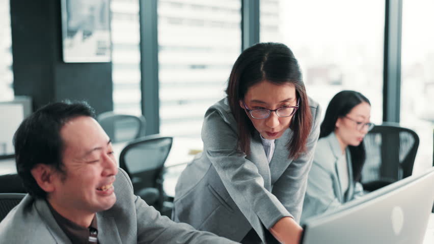 Japanese, business and people with computer in office of training support, discussion and help of finance report. Staff, mentor and explain of information, kpi feedback and investment advice in Japan