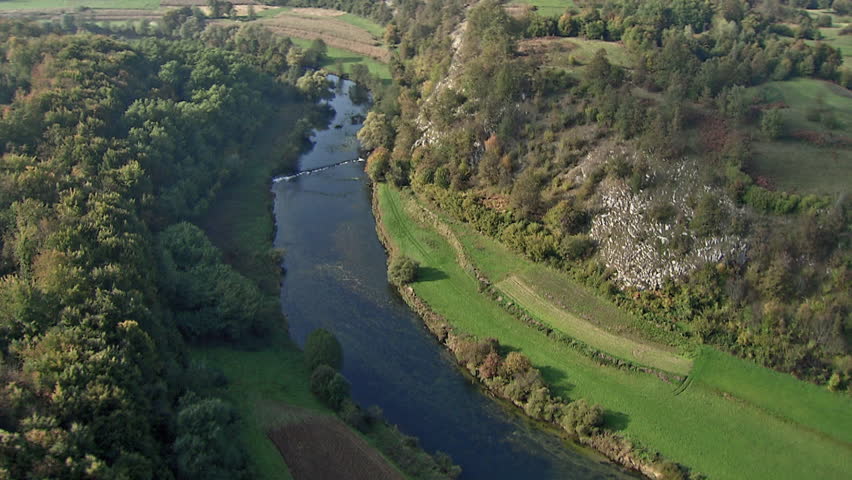 Aerial shot of a scenic river surrounded by greenery