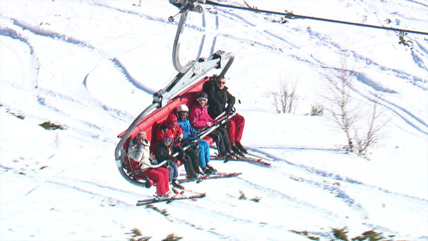 Aerial shot of people in cable car above ski track, mountain Jahorina