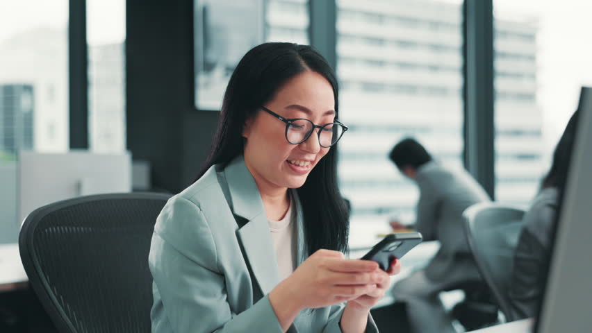 Asian businesswoman, phone or smile on break in office for good news, communication or networking. Japan, chat or city planner texting on mobile for update notification, approval email or browsing