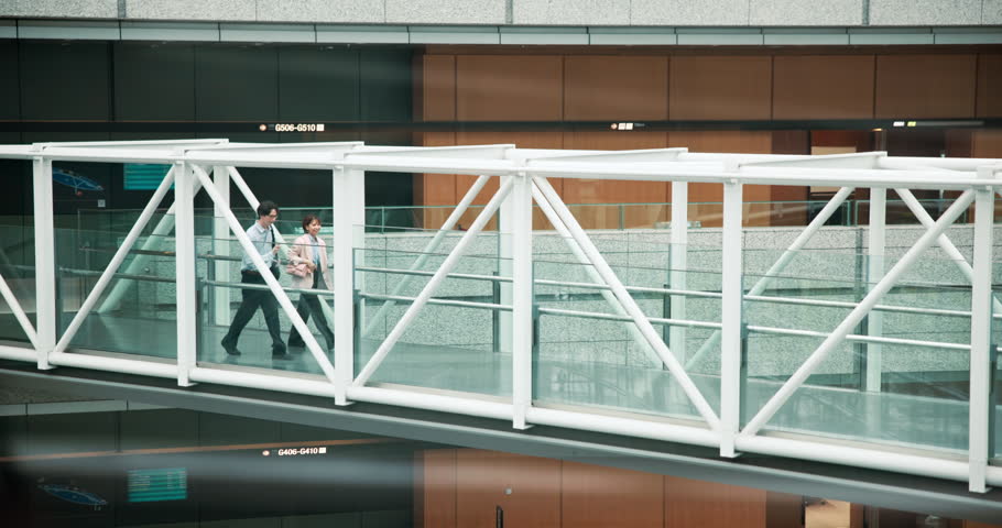Bridge, walking and business, people with conversation, planning and start day. Japan, travel and employees in city, teamwork and commute with deadline, cooperation and discussion for project