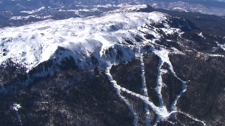 Snowy mountain Jahorina with ski tracks and tourist sports resort. Aerial