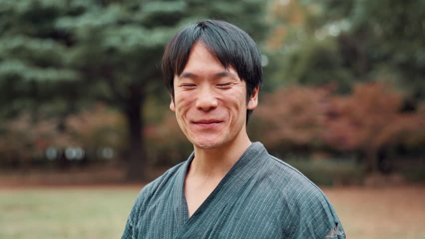 Traditional, warrior and face of asian man, martial arts and training with technique, kenjutsu and forest. Nature, smile and Japanese person in kimono, outdoor and discipline for samurai in Japan