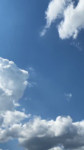 Little soft clouds grow big. Transformation of cloudscape in the blue sky. Timelapse. Vertical video.