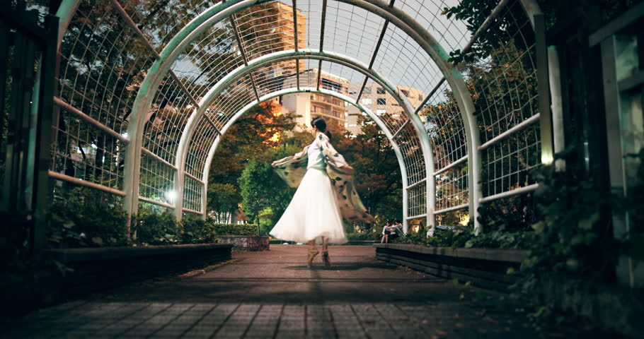 Japanese, woman and dancing in city with spin for culture, tradition and creativity. Energy, outdoor and public performance with freedom and contemporary routine with talent and artist at night