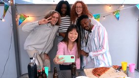 Multiracial millennial friends blowing streamers while taking selfie during birthday party at rooftop - Powered by Shutterstock - Get 15% off with code: PIKWIZARD15