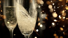 Super Slow Motion Shot of Pouring Champagne on Festive Sparkle Background, 1000fps. - Powered by Shutterstock - Get 15% off with code: PIKWIZARD15