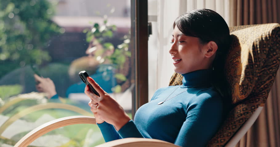 Japanese woman, break and mobile phone for relax, social media and comfort on weekend in living room. Female person, technology and scroll for rest, news and online for communication in house on app