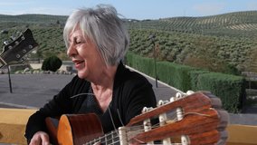 Senior spanish couple playing spanish guitar in outdoors patio - Powered by Shutterstock - Get 15% off with code: PIKWIZARD15